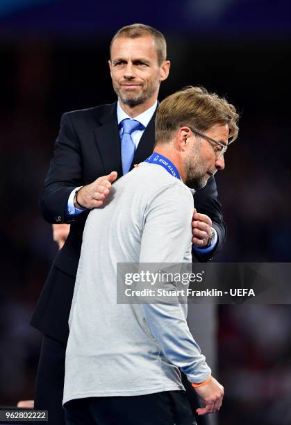 President Aleksander Ceferin gives Jurgen Klopp, Manager of Liverpool his runners up medal after the UEFA Champions League Final between Real Madrid...