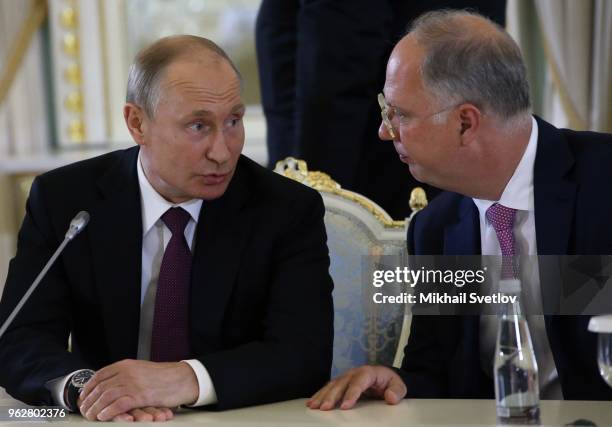 Russian President Vladimir Putin talks to Chairman of the Russian Fund for Direct Investments Kirill Dmitriev during a meeting with foreign investors...
