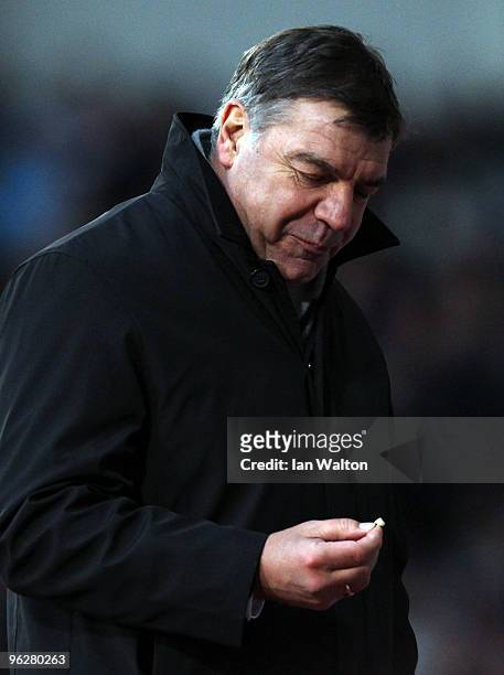 Sam Allardyce, Manager of Blackburn Rovers looks at his tooth after losing it during the Barclays Premier League match between West Ham United and...