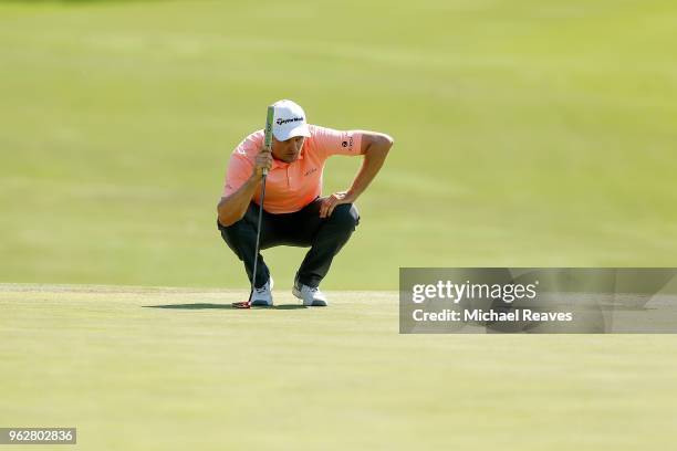 Justin Rose of England looks over a putt on the 18th green during round three of the Fort Worth Invitational at Colonial Country Club on May 26, 2018...