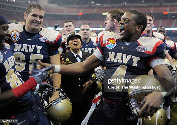 Navy's quarterback Ricky Dobbs celebrates with wide receiver Mario Washington after the game as Navy Midshipmen defeat the Missouri Tigers 35 -13 in...