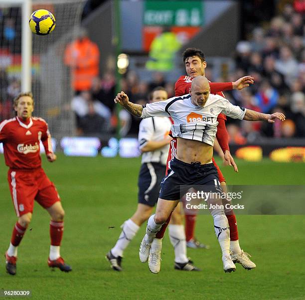 Albert Riera goes up with Gretar Rafn Steinsson of Bolton Wanderers during the Barclays Premier League match between Liverpool and Bolton Wanderers...