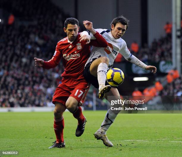 Maxi Rodriguez of Liverpool competes with Sotirios Kyrgiakos of Bolton Wanderers during the Barclays Premier League match between Liverpool and...