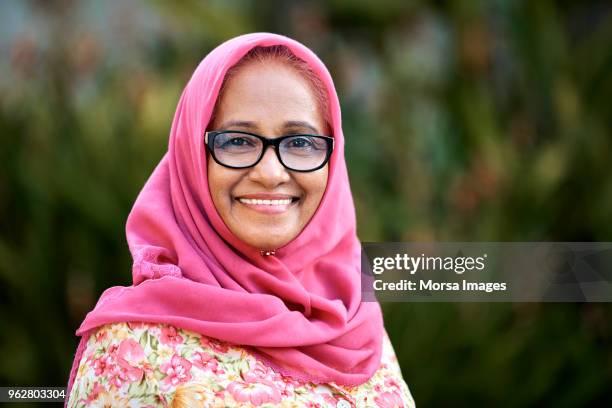 confident elderly woman in hijab at yard - asian old woman stock pictures, royalty-free photos & images