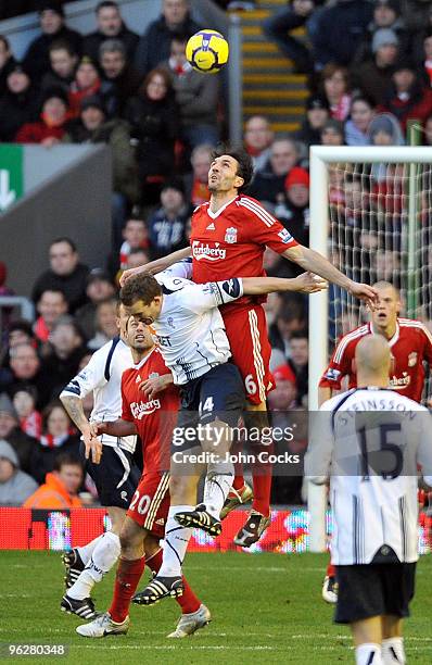 David Ngog of Liverpool goes up with Kevin Davies of Bolton Wanderers during the Barclays Premier League match between Liverpool and Bolton Wanderers...