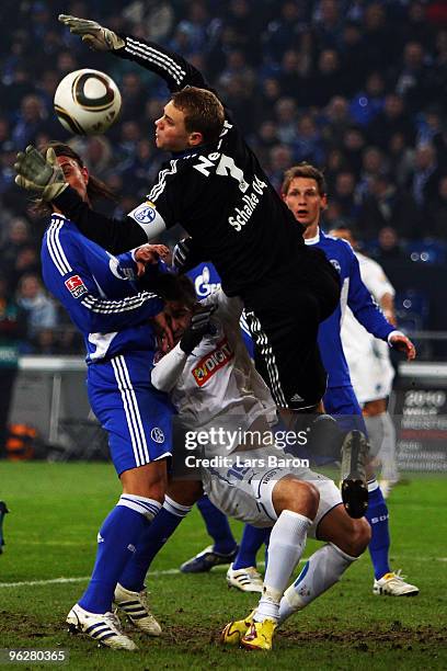 Goalkeeper Manuel Neuer of Schalke jumps over Vedad Ibisevic of Hoffenheim during the Bundesliga match between FC Schalke 04 and 1899 Hoffenheim at...