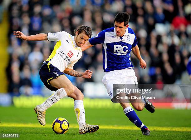 David Bentley of Tottenham is challenged by Scott Dann of Birmingham during the Barclays Premier League match between Birmingham City and Tottenham...