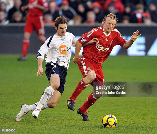 Dirk Kuyt of Liverpool competes with Samuel Ricketts of Bolton Wanderers during the Barclays Premier League match between Liverpool and Bolton...