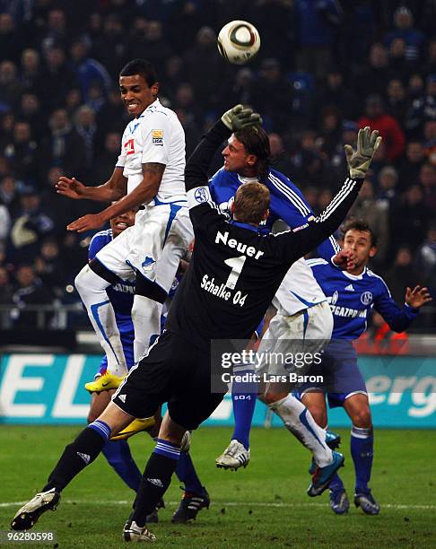 Luiz Gustavo of Hoffenheim goes up for a header next to Marcelo Bordon and goalkeeper Manuel Neuer of Schalke during the Bundesliga match between FC...