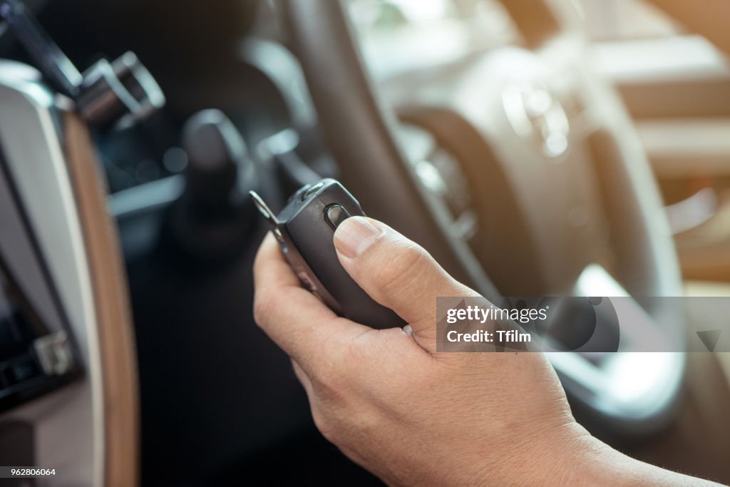 Man hand on Mobile radio in his car