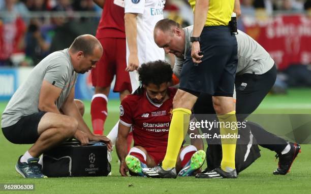 Liverpool's Mohamed Salah gets injured during the UEFA Champions League final football match between Real Madrid and Liverpool FC at the Olimpiyskiy...