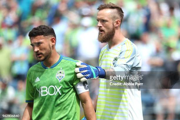Stefan Frei and Cristian Roldan of Seattle Sounders interact in the first half against the Real Salt Lake during their game at CenturyLink Field on...