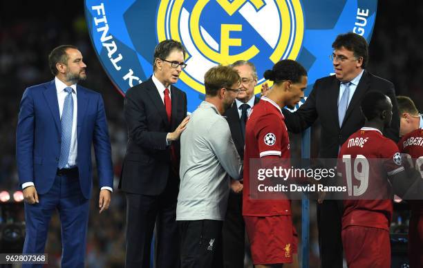 Liverpool owner John W. Henry pats Jurgen Klopp, Manager of Liverpool on the back after the UEFA Champions League Final between Real Madrid and...