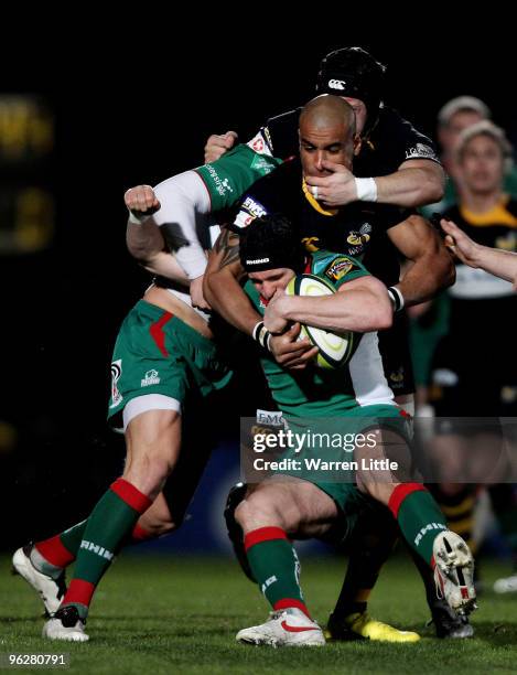 Andy Fenby of Llanelli Scarlets is tackled by Tom Varndell of London Wasps during the LV=Cup between London Wasps and Llanelli Scarlets at Adams Park...