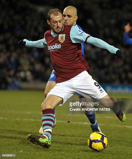 Burnley's Scottish forward Steven Fletcher beats Chelsea's Brazilian defender Alex to the ball to score the equalizing goal during the English...