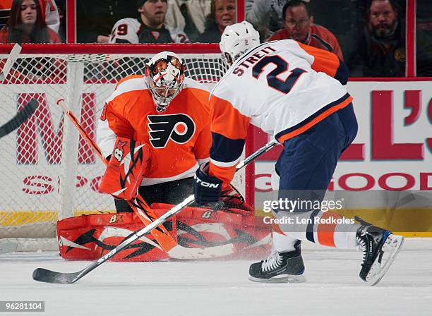 Mark Streit of the New York Islanders takes a shot from close range on goaltender Ray Emery of the Philadelphia Flyers on January 30, 2010 at the...