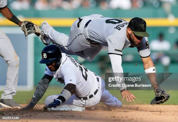 Second baseman Yoan Moncada of the Chicago White Sox tumbles over Niko Goodrum of the Detroit Tigers after turning the ball at second base during the...