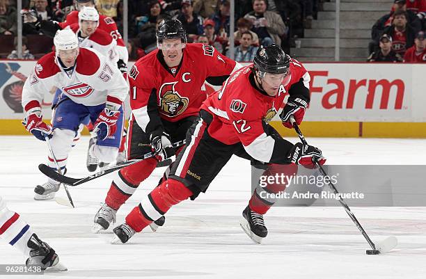 Mike Fisher and Daniel Alfredsson of the Ottawa Senators skate up ice with the puck against the Montreal Canadiens at Scotiabank Place on January 30,...