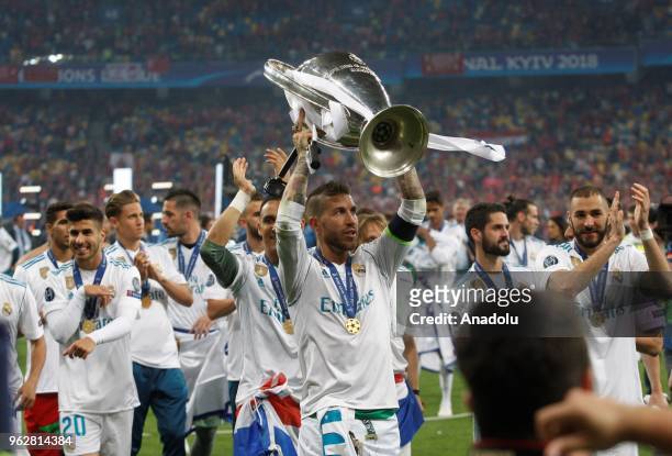 Real Madrid's Sergio Ramos raises the trophy after winning the UEFA Champions League final football match against Liverpool FC at the Olimpiyskiy...