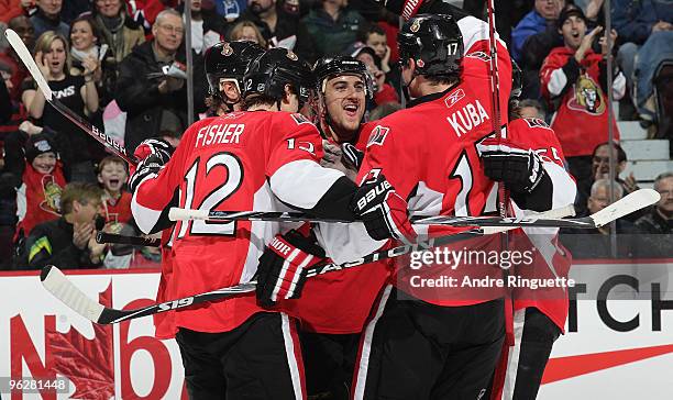 Nick Foligno of the Ottawa Senators celebrates a first period goal against the Montreal Canadiens with team mates Mike Fisher and Filip Kuba at...