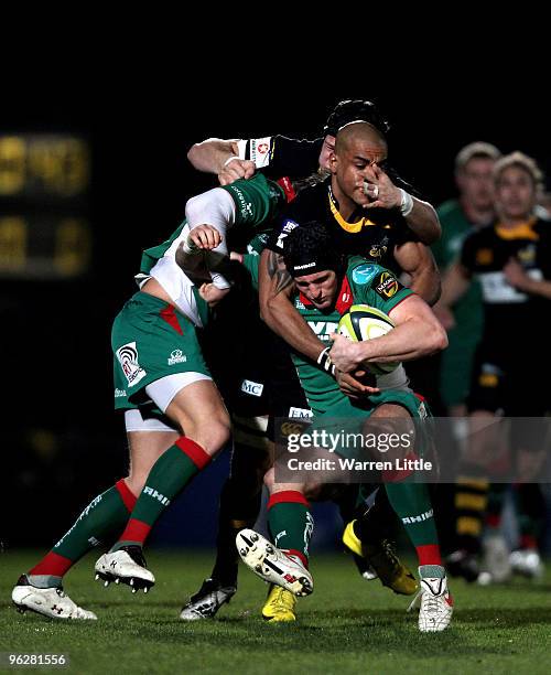 Andy Fenby of Llanelli Scarlets is tackled by Tom Varndell of London Wasps during the LV=Cup between London Wasps and Llanelli Scarlets at Adams Park...