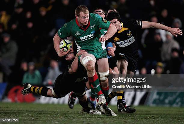 Damien Welch of The Scarlets is tackled by Will Matthews of London Wasps during the LV=Cup between London Wasps and Llanelli Scarlets at Adams Park...