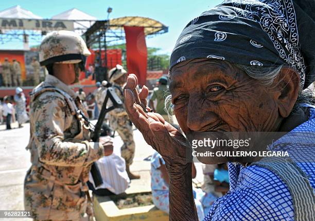 Colombian Wayuu indigenous woman gestures next to Colombian soldiers during a meeting between the army and villagers of the town of Uribia, in La...