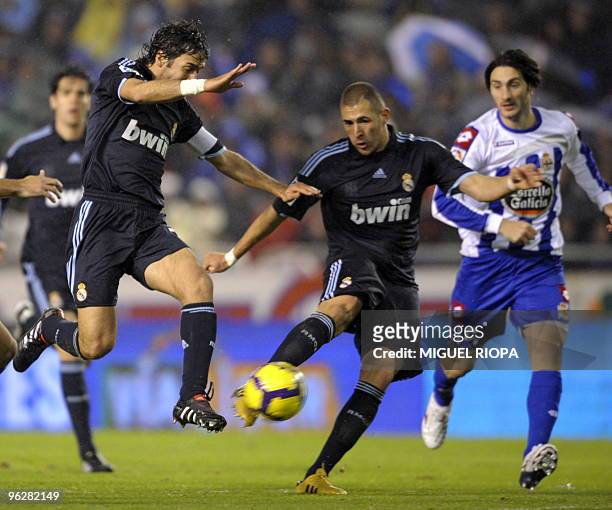 Real Madrid's captain Raul Gonzalez and teammate French forward Karim Benzema run for the ball next to Deportivo Coruna's Argentinian defender Diego...