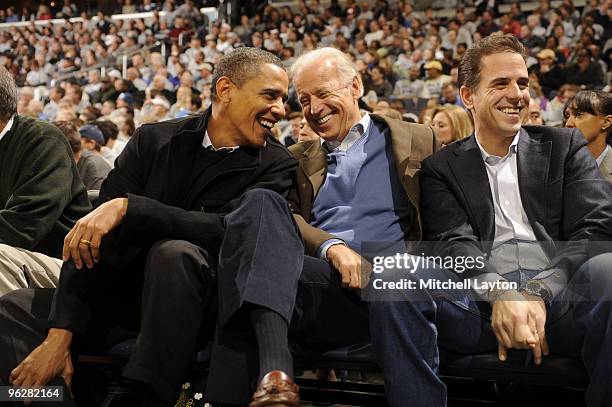 President of the United States Barack Obama and Vice President Joe Biden and Hunter Biden talk during a college basketball game between Georgetown...
