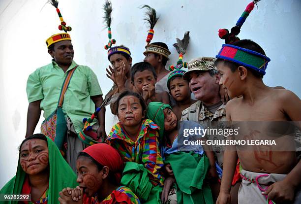 Colombian General Commander of the Military Forces Freddy Padilla poses with Colombian Wayuu indigenous children during a meeting between the army...