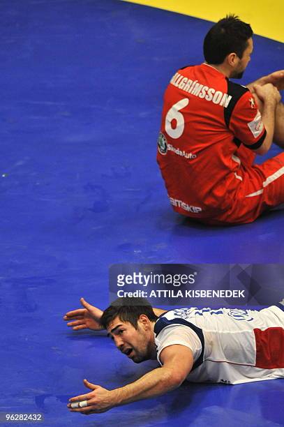 France's Nikola Karabatic gestures as he lays on the ground after being fouled on January 30 during the EHF EURO 2010 Handball Championship...