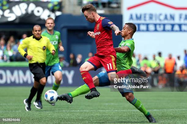 Albert Rusnak of Real Salt Lake and Jordy Delem of Seattle Sounders fight for the ball in the first half during their game at CenturyLink Field on...