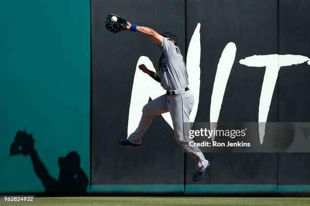 Whit Merrifield of the Kansas City Royals robs Nomar Mazara of the Texas Rangers of a hit during the fifth inning at Globe Life Park in Arlington on...