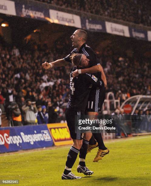 Karim Benzema of Real Madrid celebrates with Guti after scoring Real's second goal during the La Liga match between Real Madrid and Deportivo La...