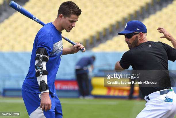 Corey Seager talks batting with third base coach Chris Woodward of the Los Angeles Dodgers before the game against the San Diego Padres at Dodger...