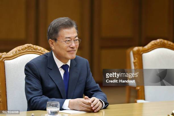 In this handout image provided by South Korean Presidential Blue House, South Korean President Moon Jae-in talks with North Korean leader Kim Jong-un...