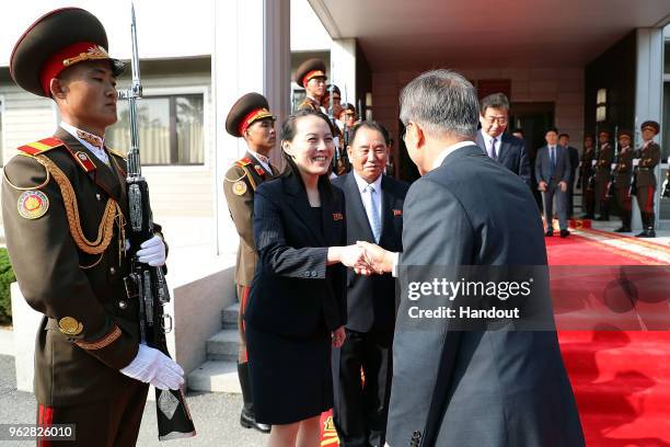 In this handout image provided by South Korean Presidential Blue House, South Korean President Moon Jae-in shakes hands with Kim Yo-Jong sister of...