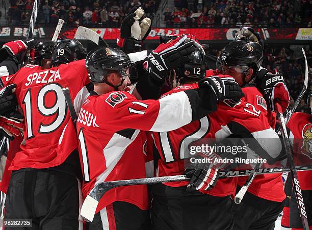 Mike Fisher of the Ottawa Senators is swarmed by Jason Spezza, Daniel Alfredsson and other team mates after scoring an overtime winning goal against...