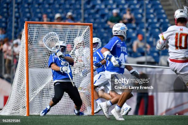 Duke University goalie Danny Fowler blocks a shot from University of Maryland middle Jared Bernhardt during the teams' NCAA Photos via Getty Images...