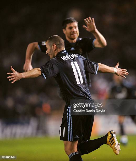Karim Benzema of Real Madrid celebrates with Xabi Alonso after scoring Real's third goal during the La Liga match between Real Madrid and Deportivo...