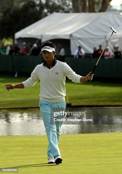 Ryuji Imada of Japan reacts as his birdie putt falls on the 18th hole at the South Course at Torrey Pines Golf Course during the third round of the...