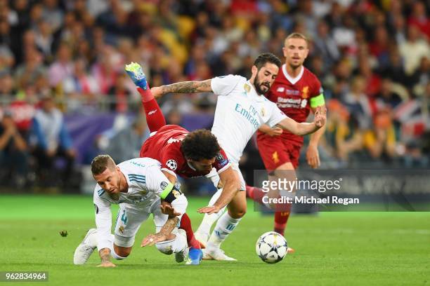 Mohamed Salah of Liverpool falls and lands on his shoulder after a collision with Sergio Ramos of Real Madrid, leading to him going off injured...