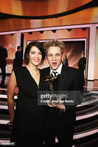 Actor Matthias Schweighoefer poses with his award 'Best Actor National' with partner Anni Schramm during the Goldene Kamera 2010 Award at the Axel...