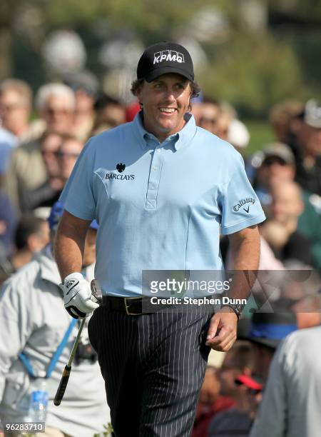 Phil Mickelson smiles as he is cheered as he walks onto the 16th tee at the South Course at Torrey Pines Golf Course during the third round of the...