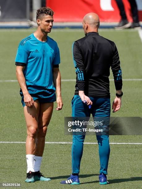 Cristiano Ronaldo of Real Madrid speaks with Head coach Zinedine Zidane of Real Madrid during a training session at the Real Madrid Open Media Day at...