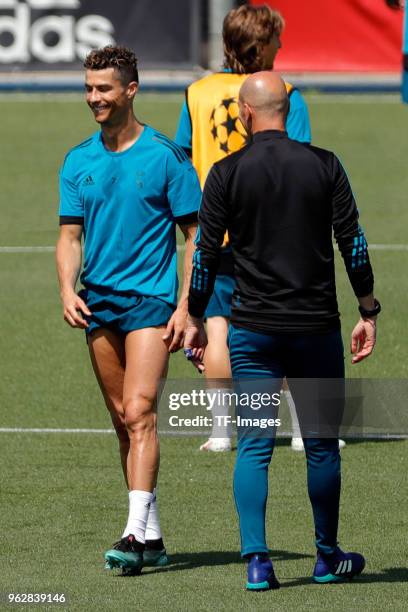 Cristiano Ronaldo of Real Madrid speaks with Head coach Zinedine Zidane of Real Madrid during a training session at the Real Madrid Open Media Day at...