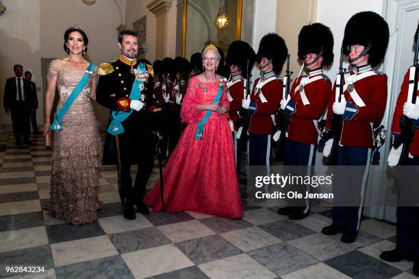 Queen Margrethe of Denmark as host for the evening leads Crown Prince Frederik and Crown Princess Mary to the Knights hall where the gala banquet on...