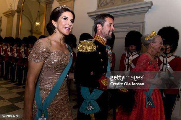 Queen Margrethe of Denmark as host for the evening leads Crown Prince Frederik and Crown Princess Mary to the Knights hall where the gala banquet on...