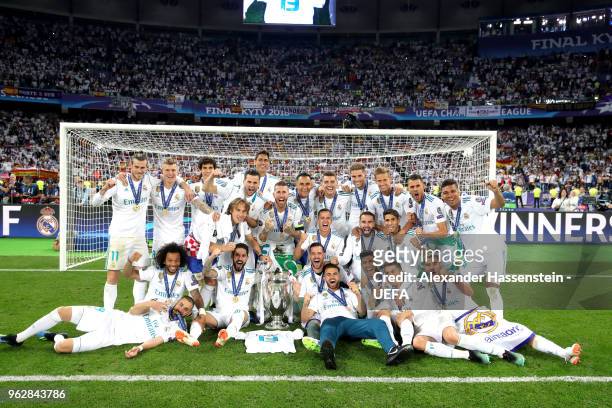 The Real Madrid team celebrate with UEFA Champions League trophy following their sides victory in the UEFA Champions League Final between Real Madrid...
