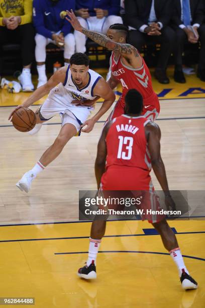 Klay Thompson of the Golden State Warriors drives with the ball against Gerald Green of the Houston Rockets during Game Six of the Western Conference...